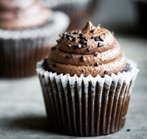 Chocolate cupcakes on rustic wooden background